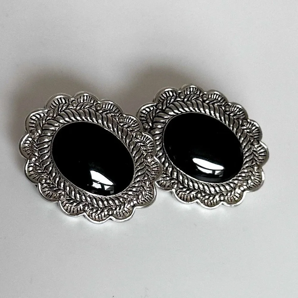 Vintage Sterling Silver Oval Clip-On Earrings with a black stone.